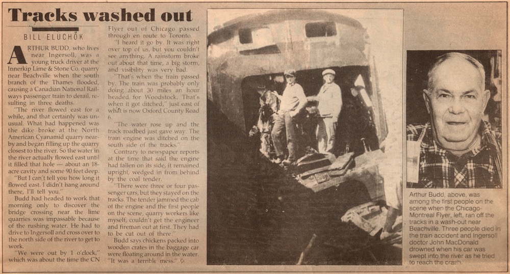A newspaper clipping titled Tracks washed out with an image of a trainwreck and a portrait of an older man