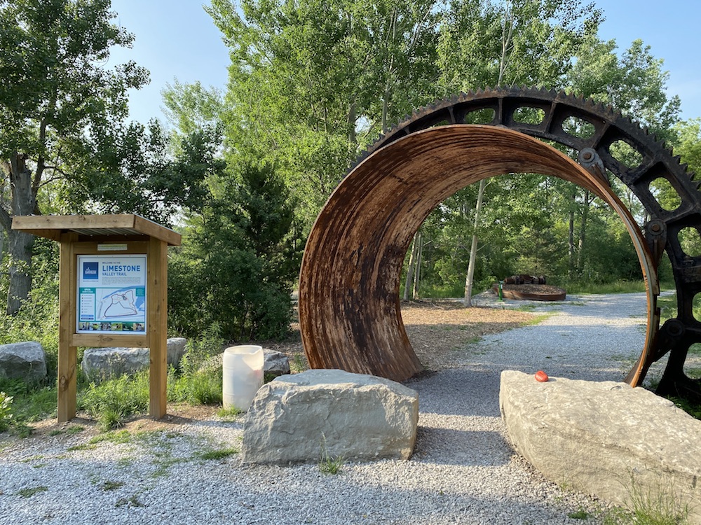 A view of a kiln shell entrance and sign to a hiking trail