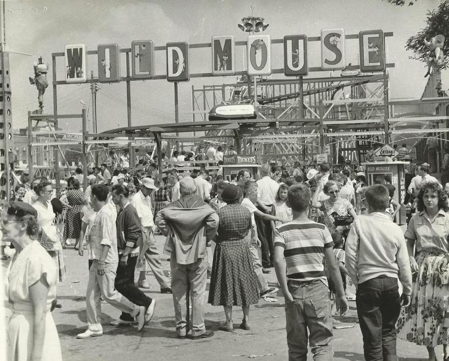 Black and white photo of a crowded carnival midway featuring the Wild Mouse roller coaster