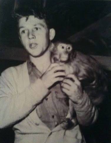 Black and white photo of young Bingo Hauser holding a monkey