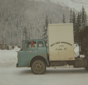 A transport truck for West Coast Amusements Ltd., outdoors during the winter