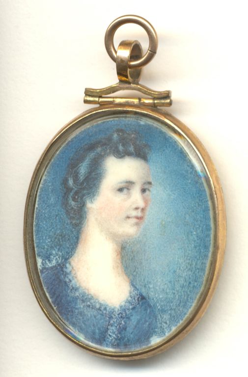 Gold locket with a painting of a woman with brown hair wearing a blue dress.