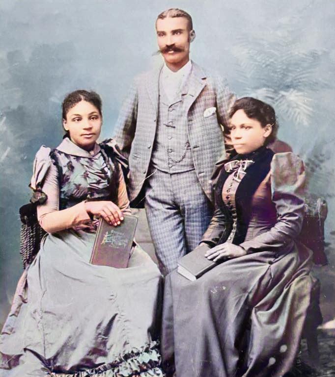 Colourised photograph of three well-dressed persons of colour. Mary Matilda Winslow is seated on the left, with her father standing behind her, and her mother seated on the right.
