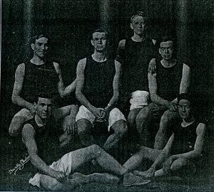 Six men grouped together wearing basketball uniforms.