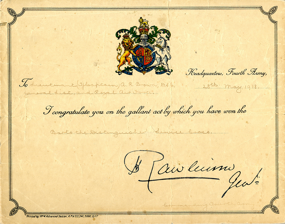 Coloured certificate with a coloured coat of arms at the top, scroll work around the edges and writing in the centre.