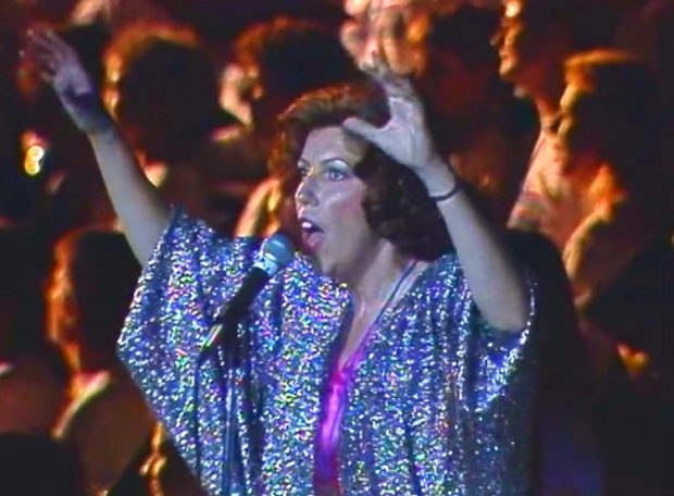 Soloist Joelle Rabu sings at the Celebration '90 Closing Ceremonies with chorus pictured behind her.