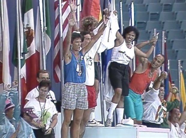 Athletes kid around and pose atop a multi-tiered podium at the Closing Ceremonies set up for last-minute photo-ops at the Closing Ceremonies.