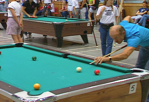 Man lines up a shot at Billiards competition.