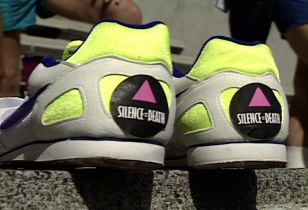 Running shoes with 'Silence=Death' stickers on their heels in the stands at Swanguard Stadium, Burnaby.