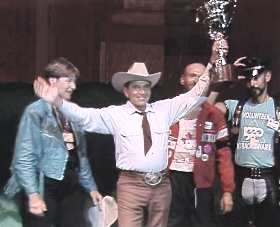 Sarah Lewinstein, The Tom Waddell Award recipient and Gay Games co-founder Paul Mart, Brent Nicholson Earle, and Robert Neyts, the Vancouverite who conceived of the award and raised the funds for the Dr. Tom Waddell Trophy. On stage at Celebration' 90 Closing Ceremonies at B.C. Place Stadium, August 11, 1990.