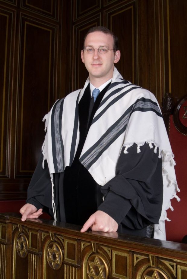 Rabbi Adam Scheier wearing formal robes and a prayer shawl.
