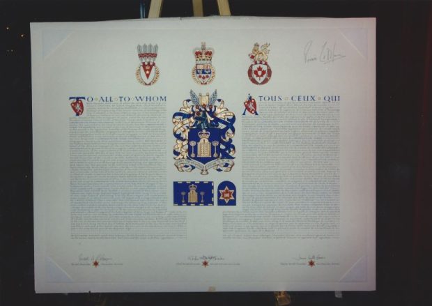 A poster board displaying the official grant of a coat of arms to Congregation Shaar Hashomayim.