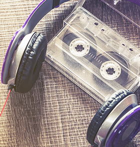 Photograph featuring headphones and audio cassette