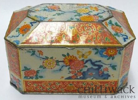 Metal biscuit tin with orange, blue, yellow, and red floral design
