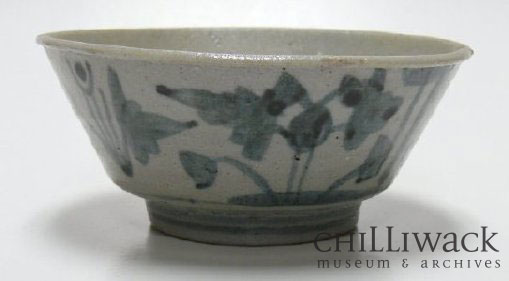 Light blue ceramic bowl with dark blue floral design on sides.