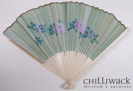 Opened hand-held fan with floral design made with blue paper