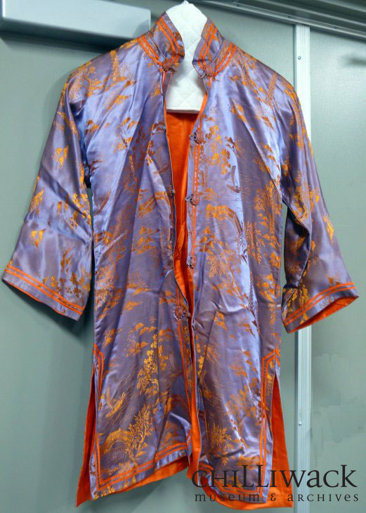 Purple and orange Chinese silk dress with design featuring trees, mountains, a boat, bridge and pagoda