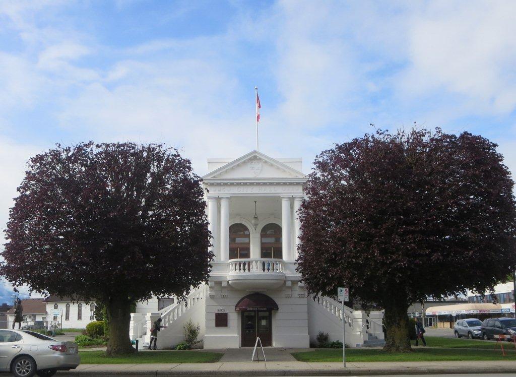 Photograph of the Chilliwack Museum with two trees in foreground