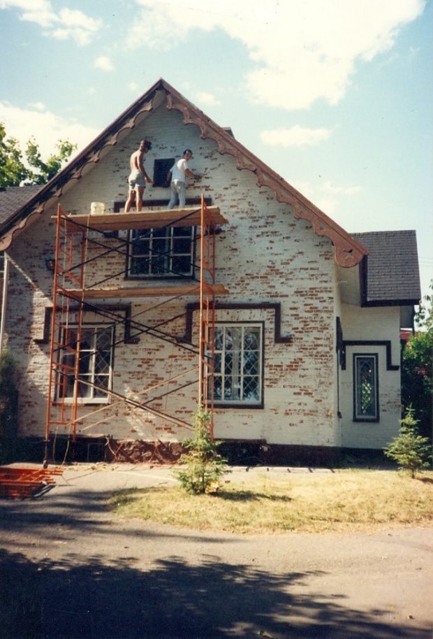 Colour photo of a cream house getting renovated.
