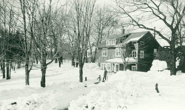 Picture of a house sitting in snow with a path to the front door