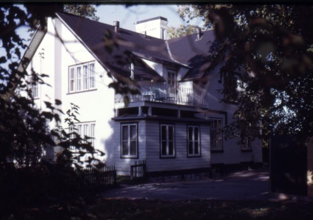 colour picture of a house surrounded by trees