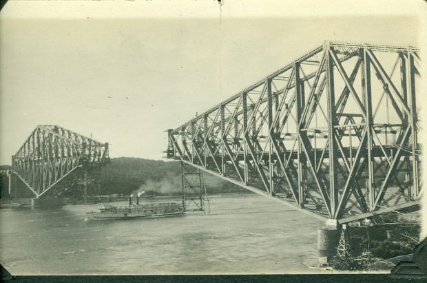 sepia photo of a bridge with no center span