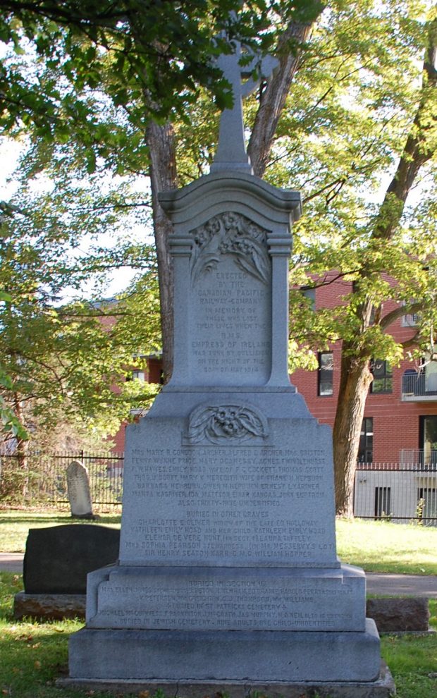 Large marble monument surrounded by trees in the shade