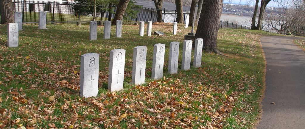 headstone in line with fall leaves all around them