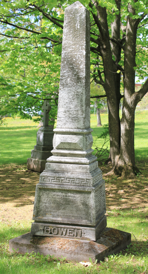 Coloured picture of a tombstone in the grass and surrounded by trees