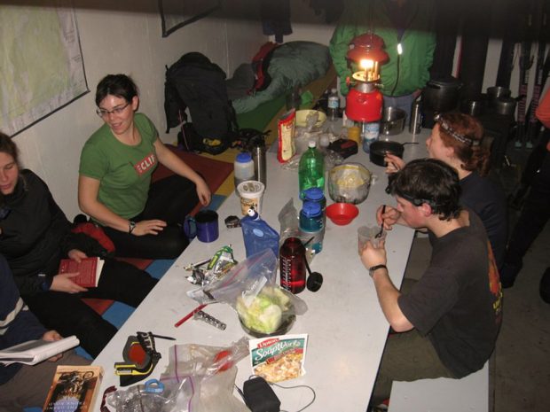 Club members enjoying spending time with one another and eating a warm meal at the dining room table.