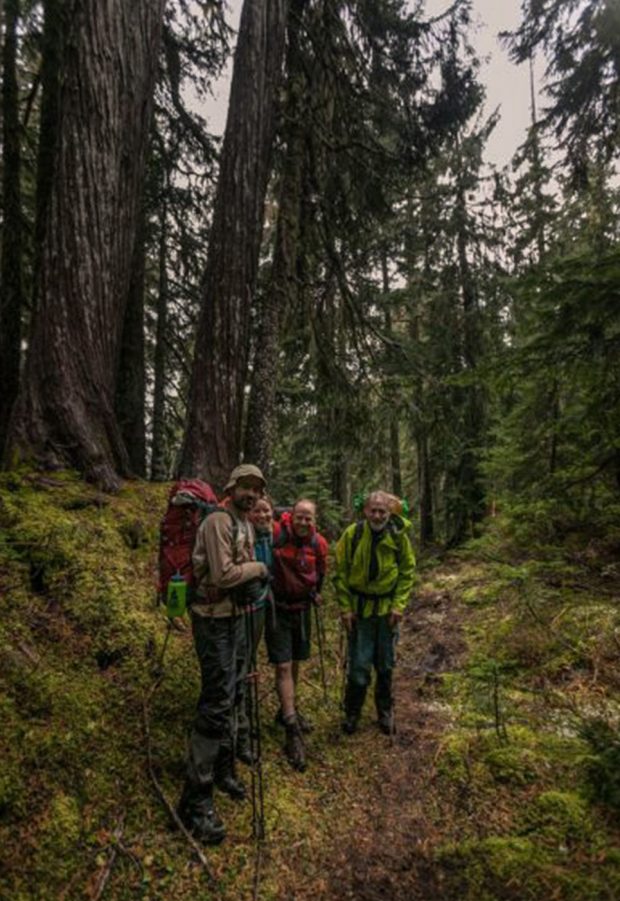 A group portrait of club members hiking on the trail to the Watersprite Lake Hut.