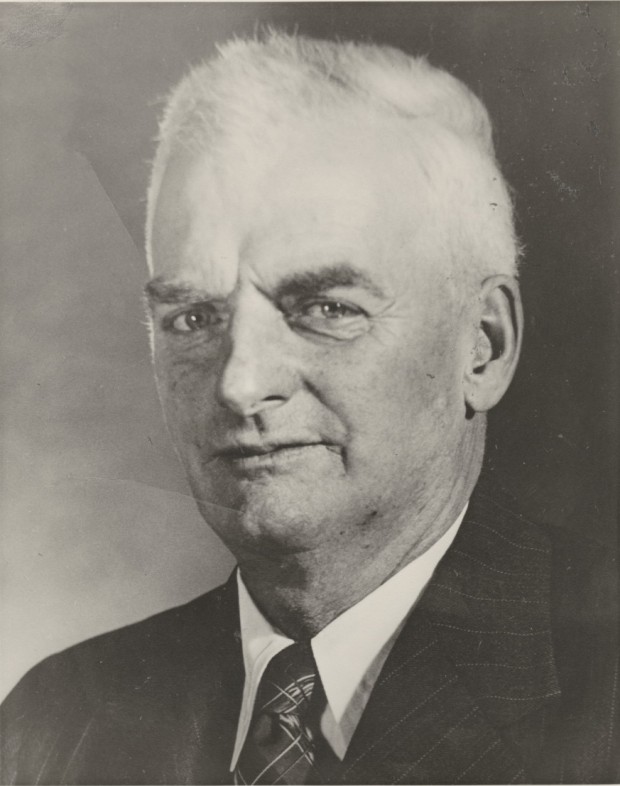 Photograph of Mr. Frank Bickle facing camera with short white hair, white shirt, jacket and tie