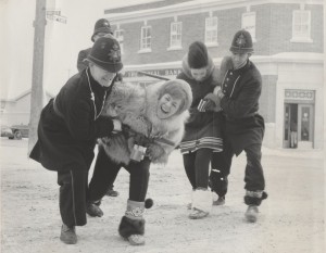 keystone kops arresting two fur queen contestants outside in front of a bank