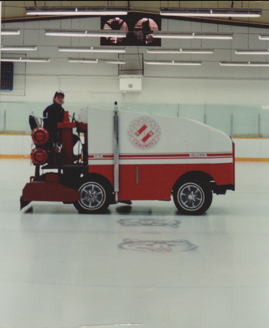 Man driving zamboni on indoor rink