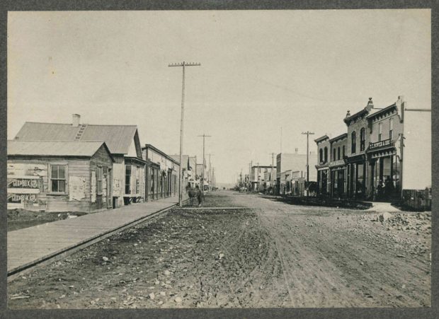 1880s Photo of Stephen Avenue - the original Lougheed home is the second building on the left with the bay window.