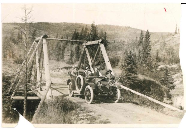 Family in car on bridge near Banff