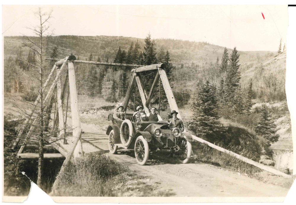 Family in car on bridge near Banff