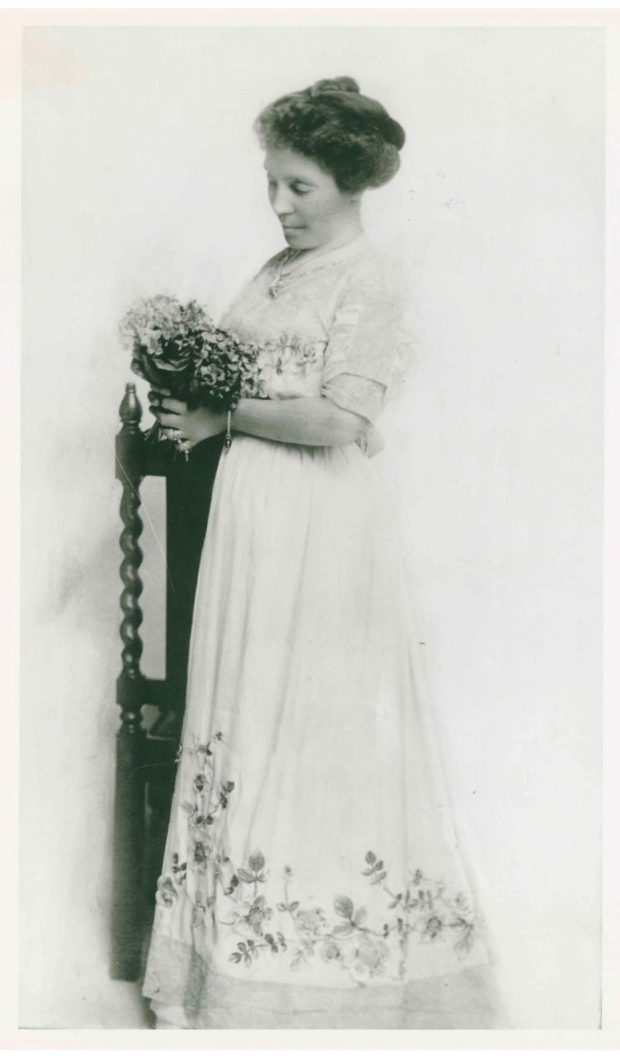 Photo of Belle Lougheed holding bouquet of flowers