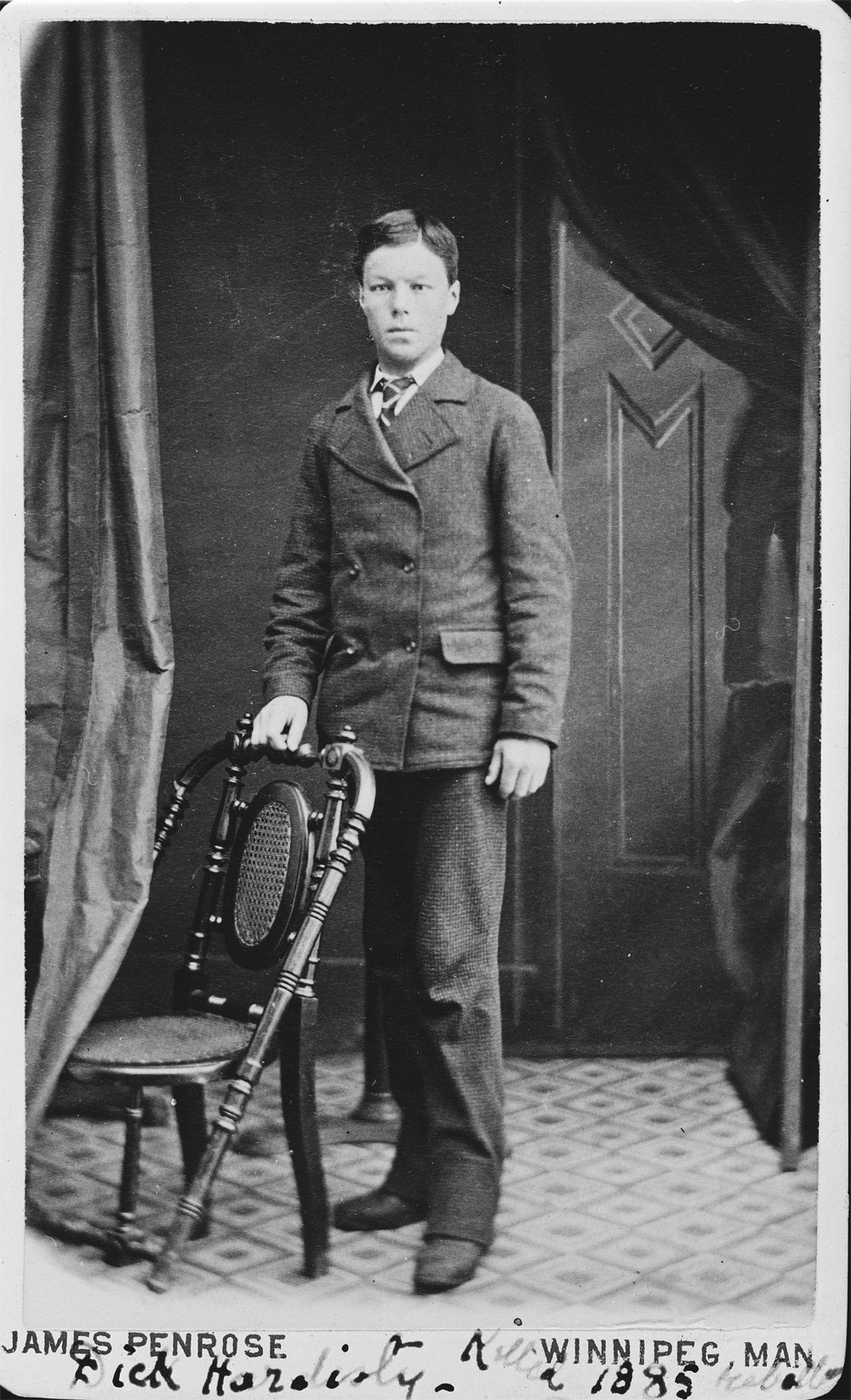 Formal photo of Dick Hardisty as young man in a suit.