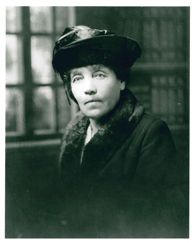 A portrait of Belle Lougheed in hat and winter coat with fur collar.