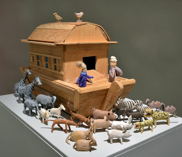 Sculpture of wooden boat with several animals