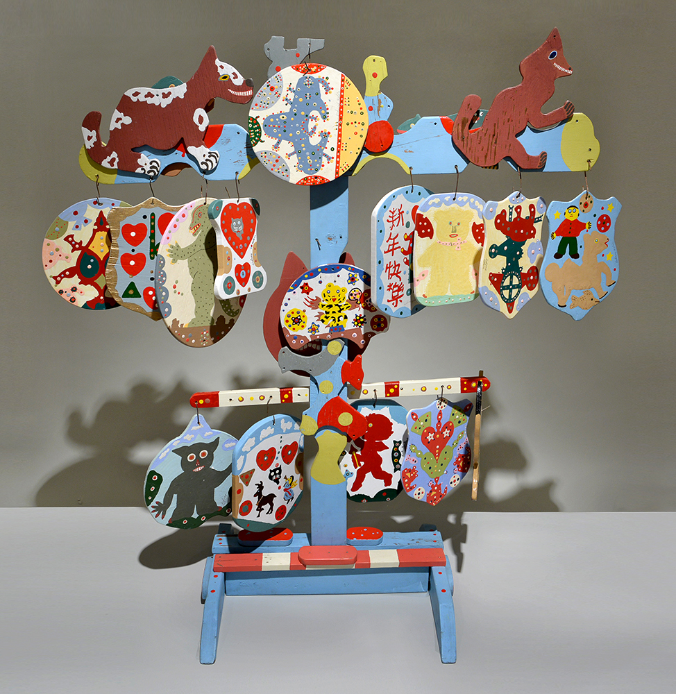 Blue wooden stand with several pictures hanging from it. Pictures are of various creatures and patterns.