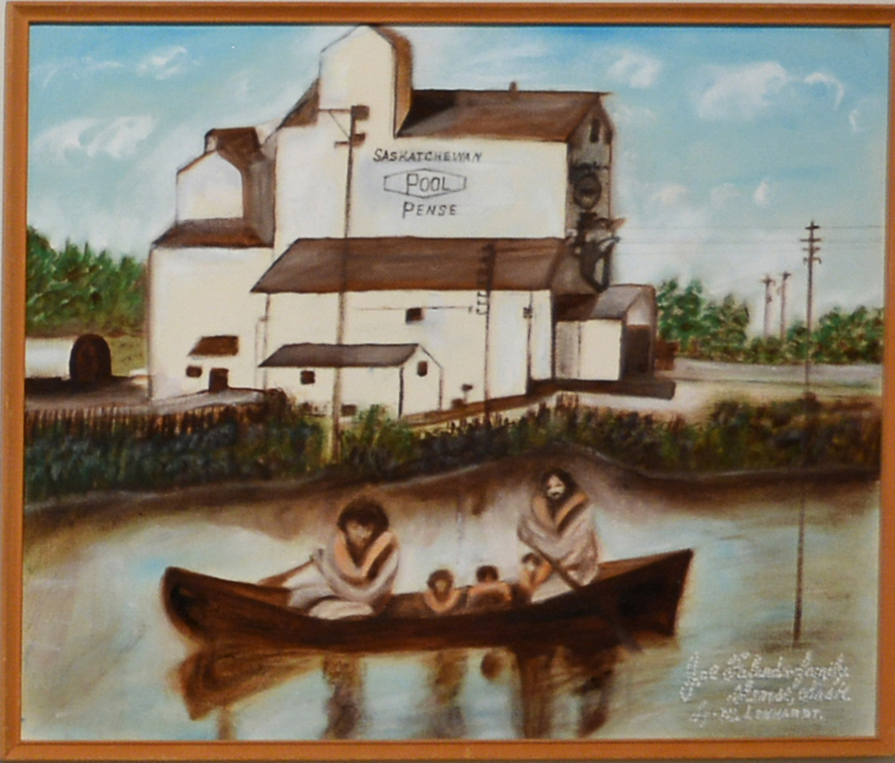 Family canoeing in front of a grain elevator