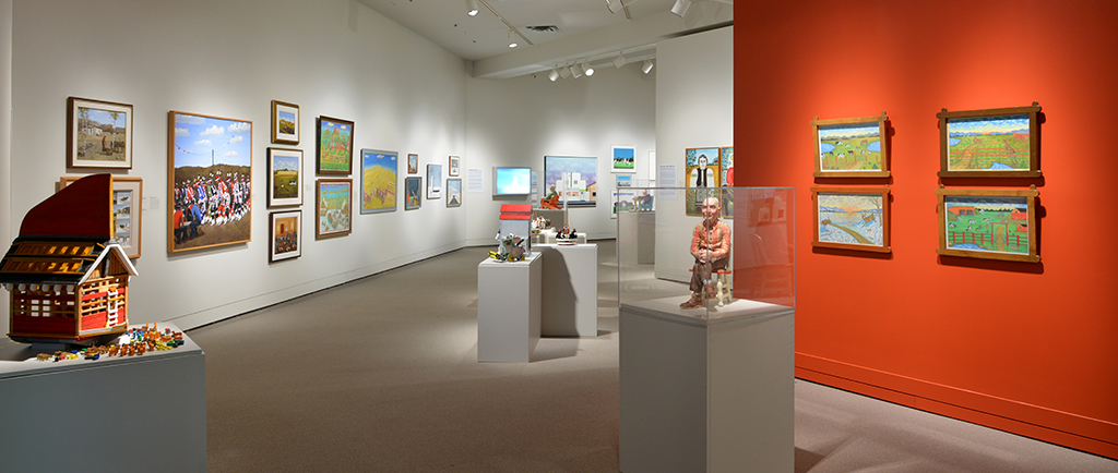 View of an art gallery space full of several artworks