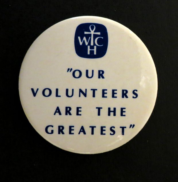 White pin with black Women’s College Hospital logo and text. Text reads: Our Volunteers are the Greatest.