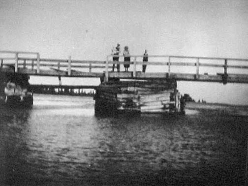 People standing on the aboiteau over Cole Harbour