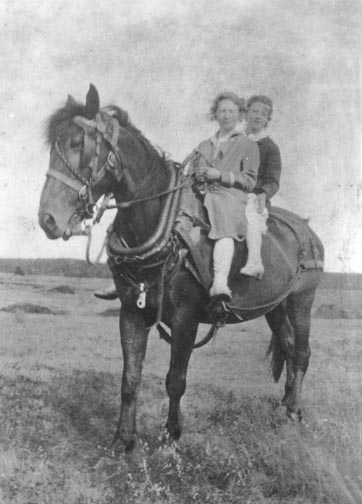 Two girls on horseback on the dyke