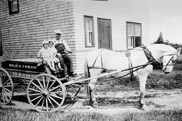 Thomas Bisset with his two sons in front of his house