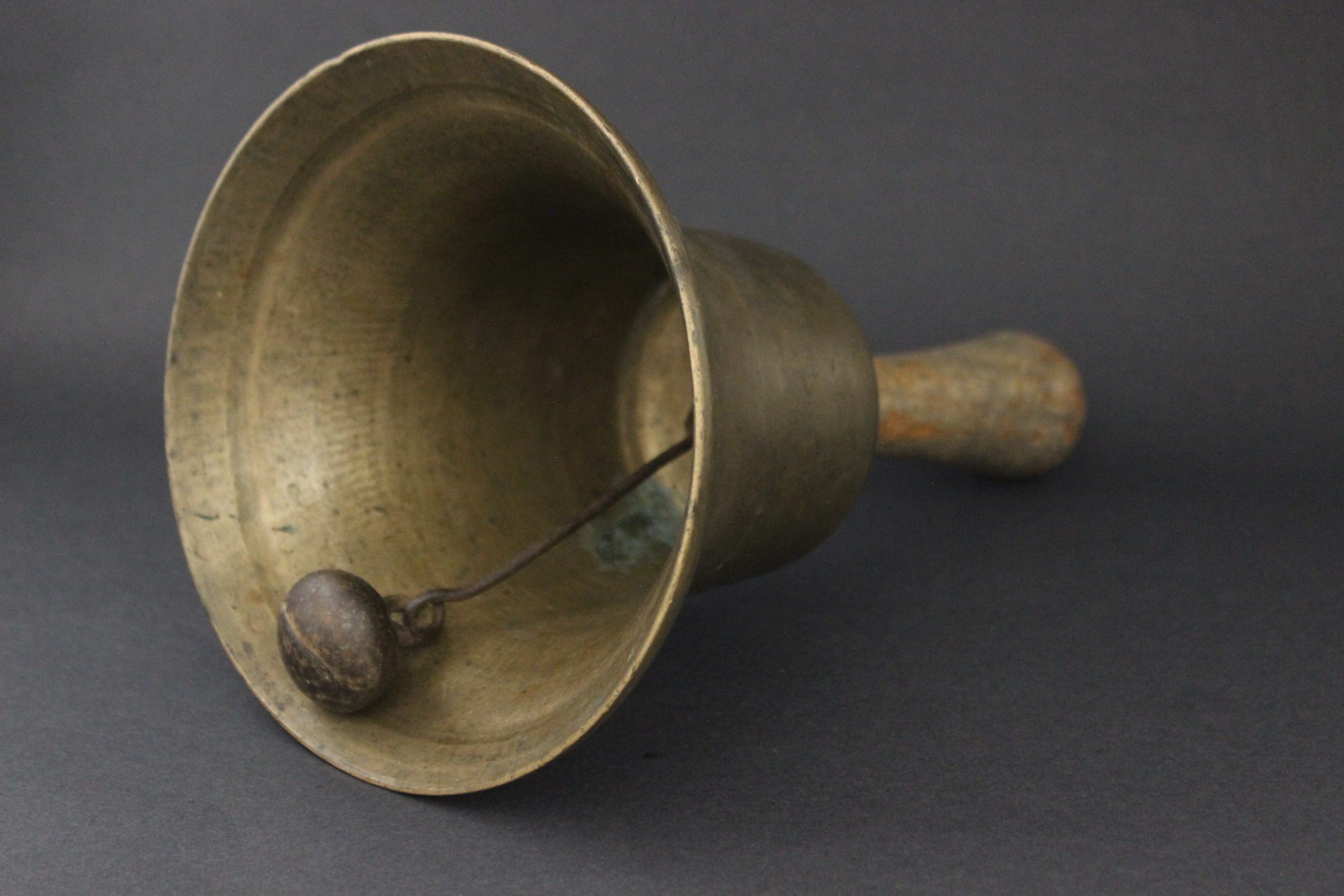 Brass school bell with wooden handle.