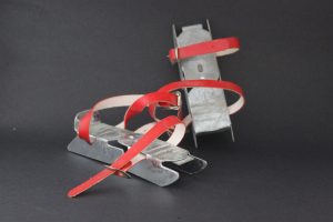 Metal blades with red straps to attach to boots.